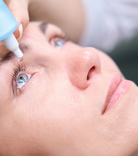 Person having drops applied to their eye