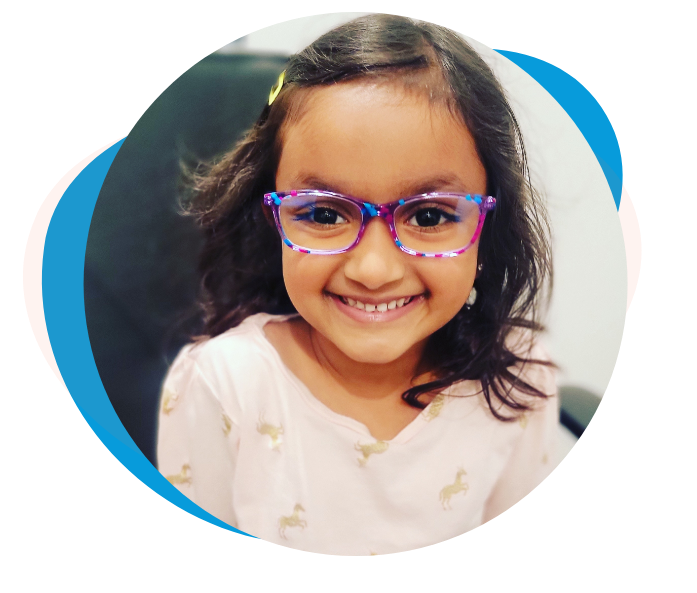 Young girl smiling at her optometrist after an eye exam for kids