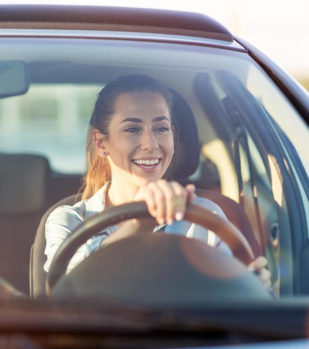 Smiling woman driving a car