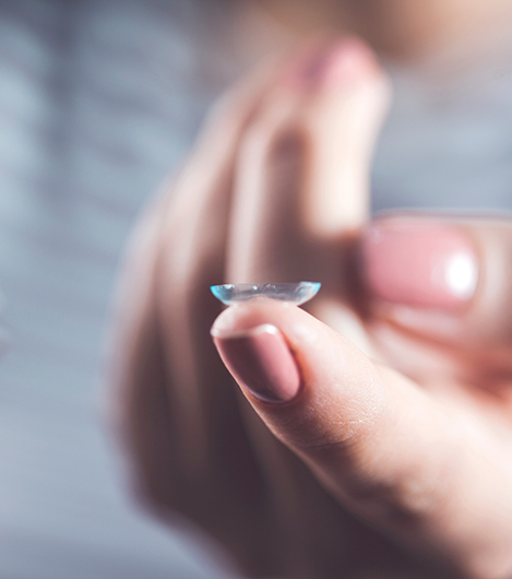 Close up of a person holding a contact lens on their finger