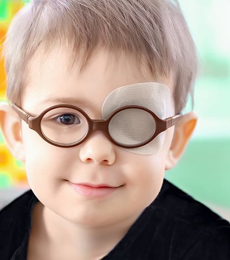 Young boy with a bandage over one eye