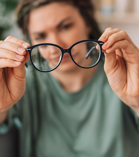 Woman holding a pair of glasses