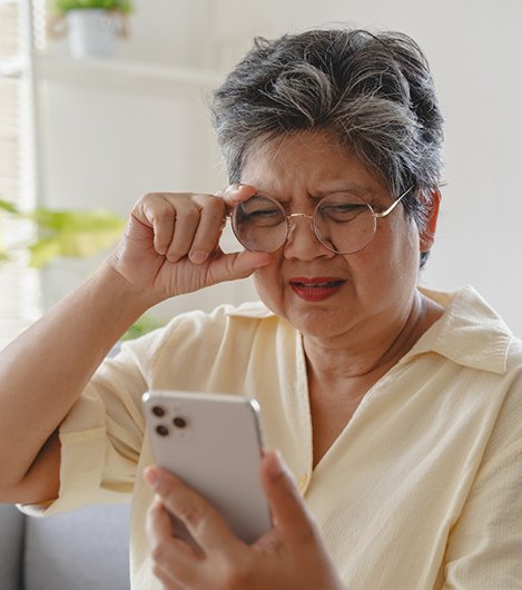 Woman squinting at her phone