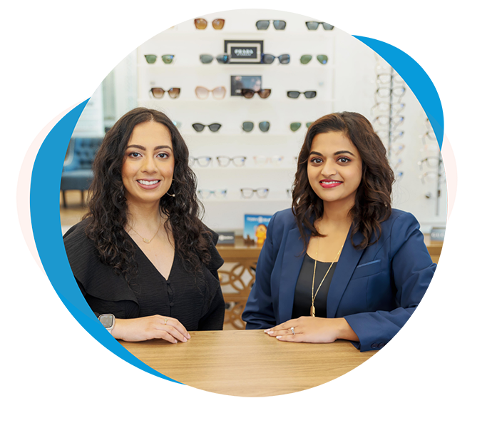 Two Richmond optometrists smiling at a desk