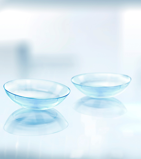 Close up of two contact lenses on a flat surface