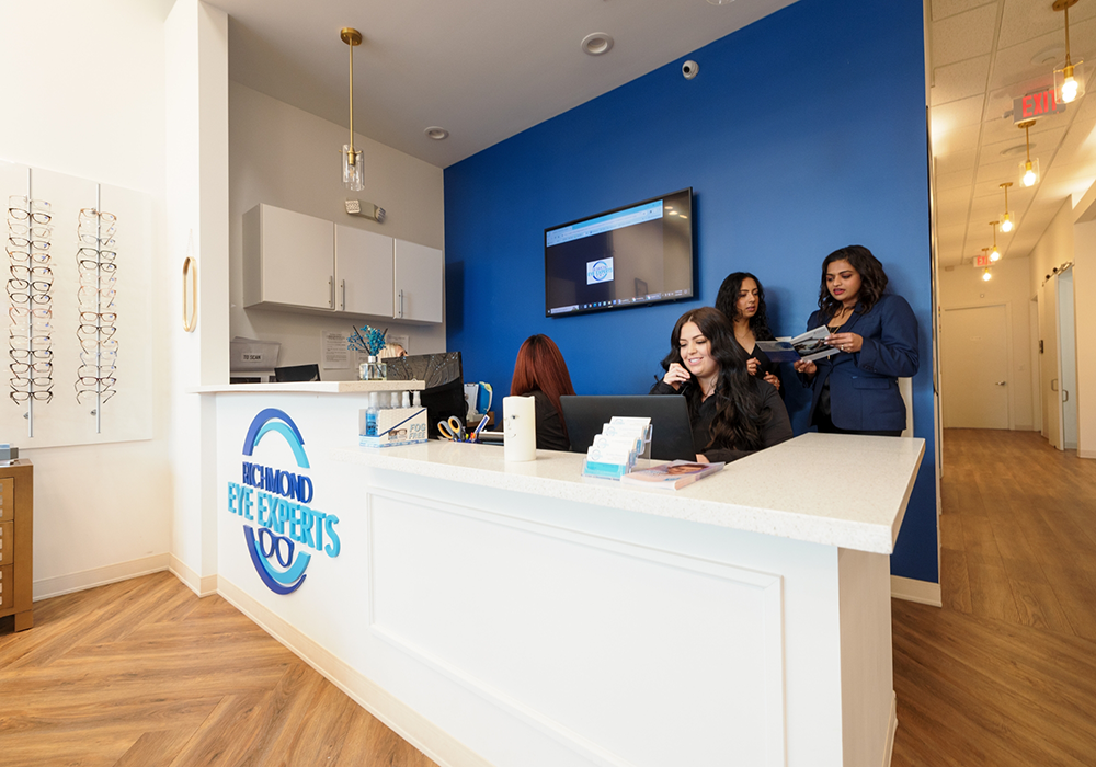 Team members talking on phone behind front desk