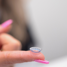 Close up of a contact lens on a finger